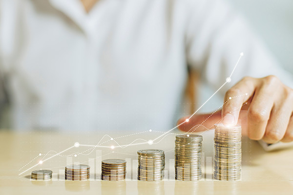 Hand hold coin and coins stack with white up arrow.