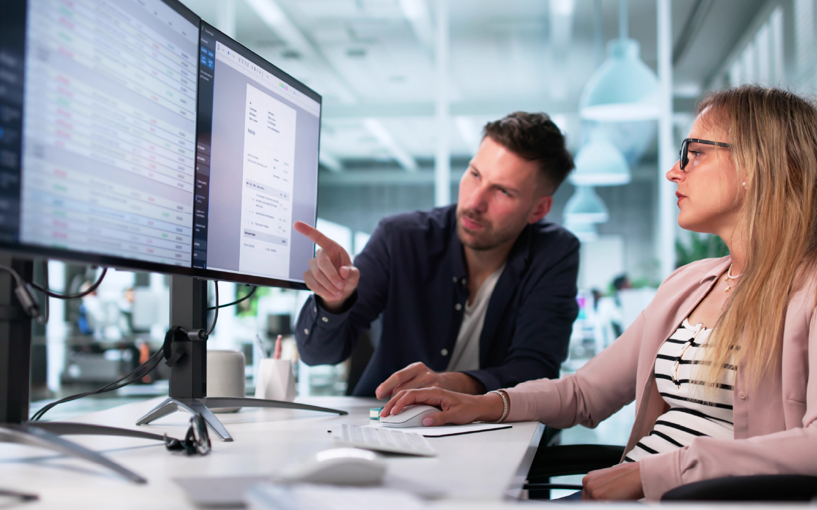 coworkers discussing DME Billing at a desktop