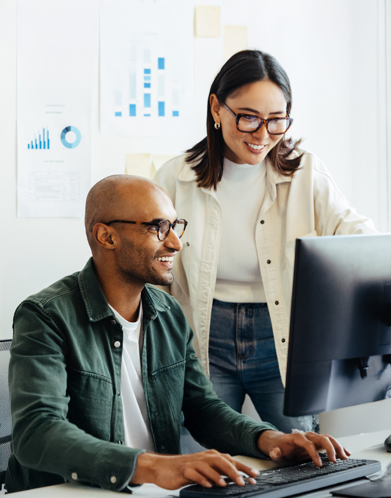coworkers working together over a computer screen
