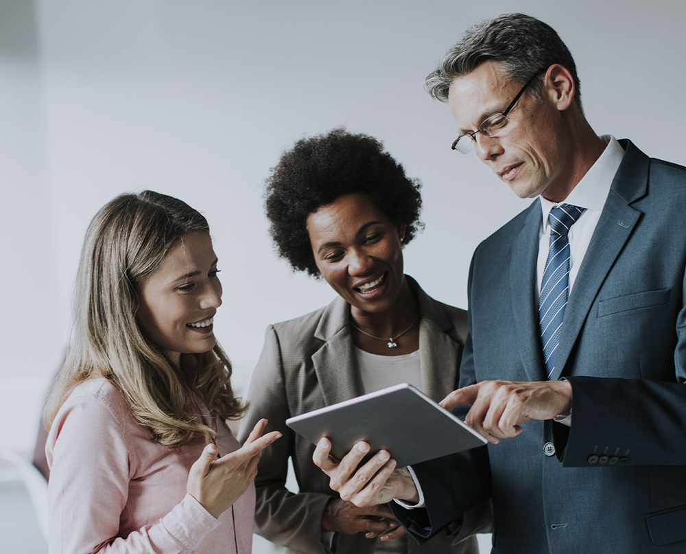 Associates talking together over a tablet