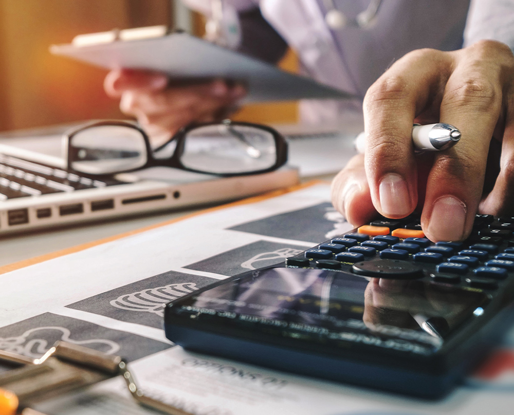 medical biller using a calculator to check numbers