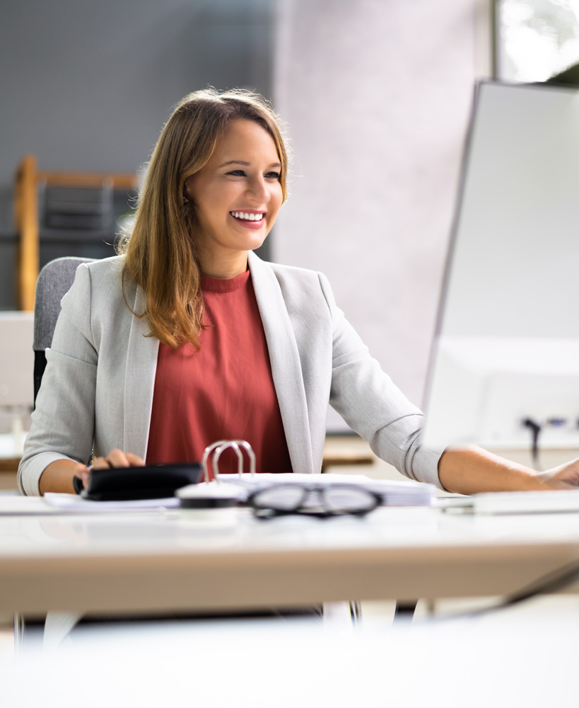 woman in suit inputing information into computer