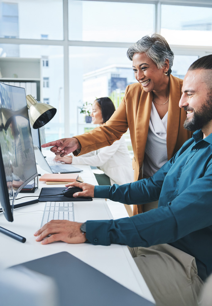 dme training with instructor overseeing 2 employees and their computer screens