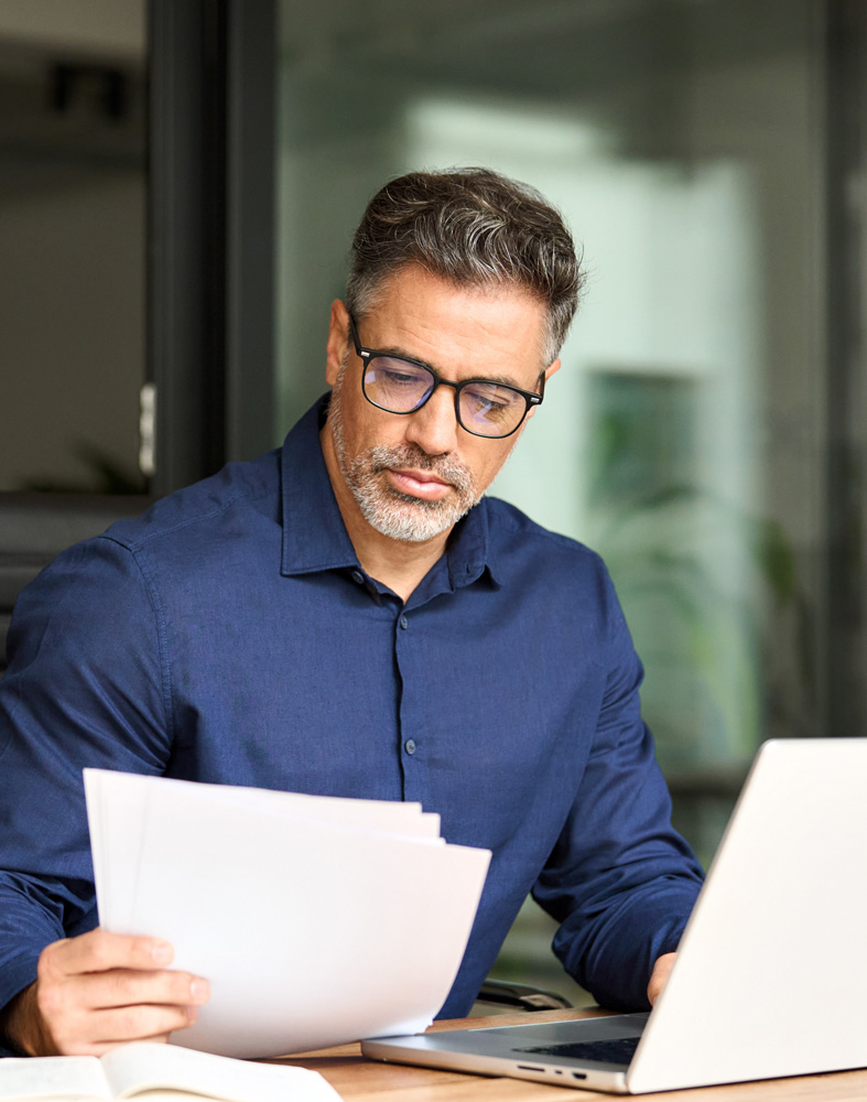 Young woman holding claim documents checking information in office