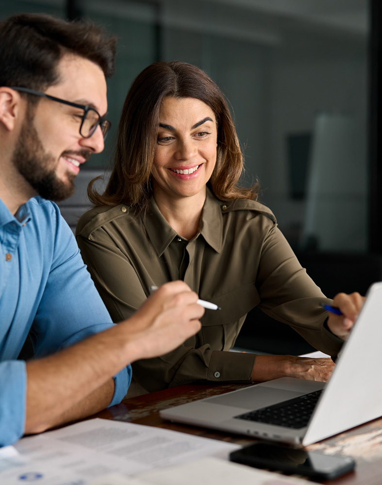 two happy professional business people team using laptop computer discussing information in office