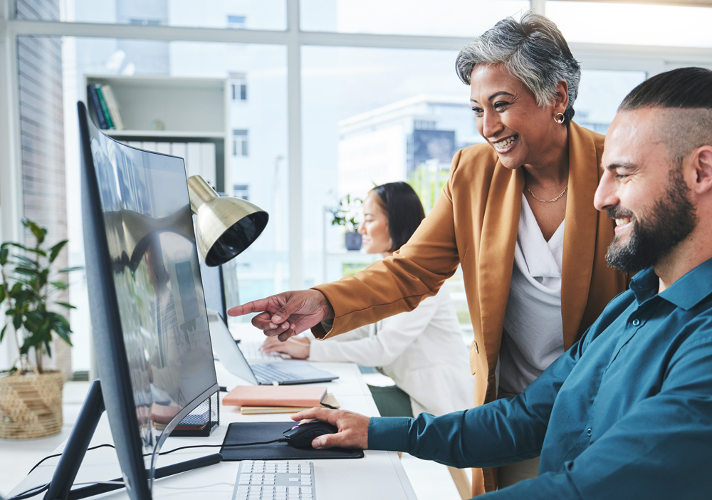 dme training with instructor overseeing 2 employees and their computer screens