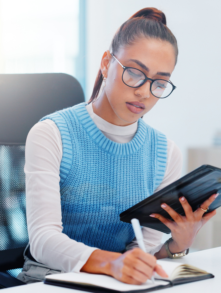 woman holding tablet reviewing documents