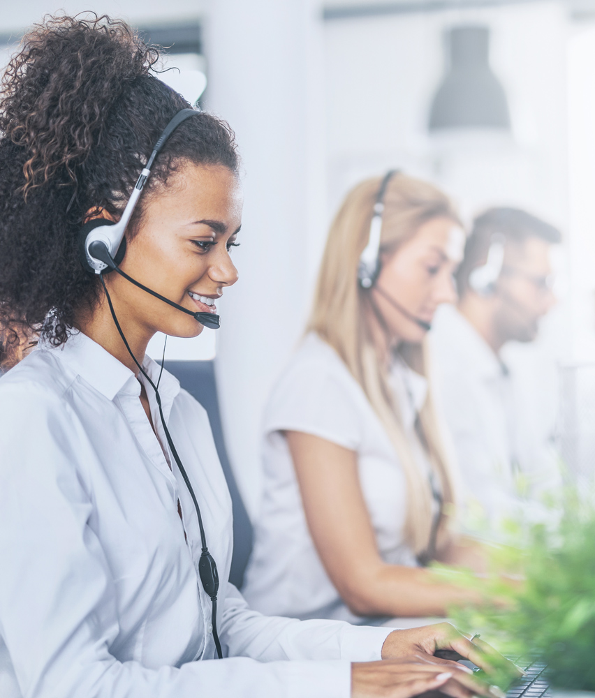 Medbill worker with headset in front of her computer accompanied by her team