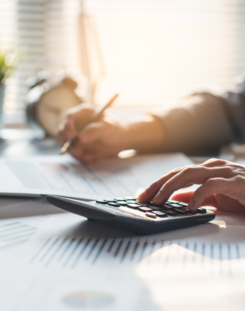 Revenue Cycle Management 1 Businessman computing numbers from spreadsheets and calculator