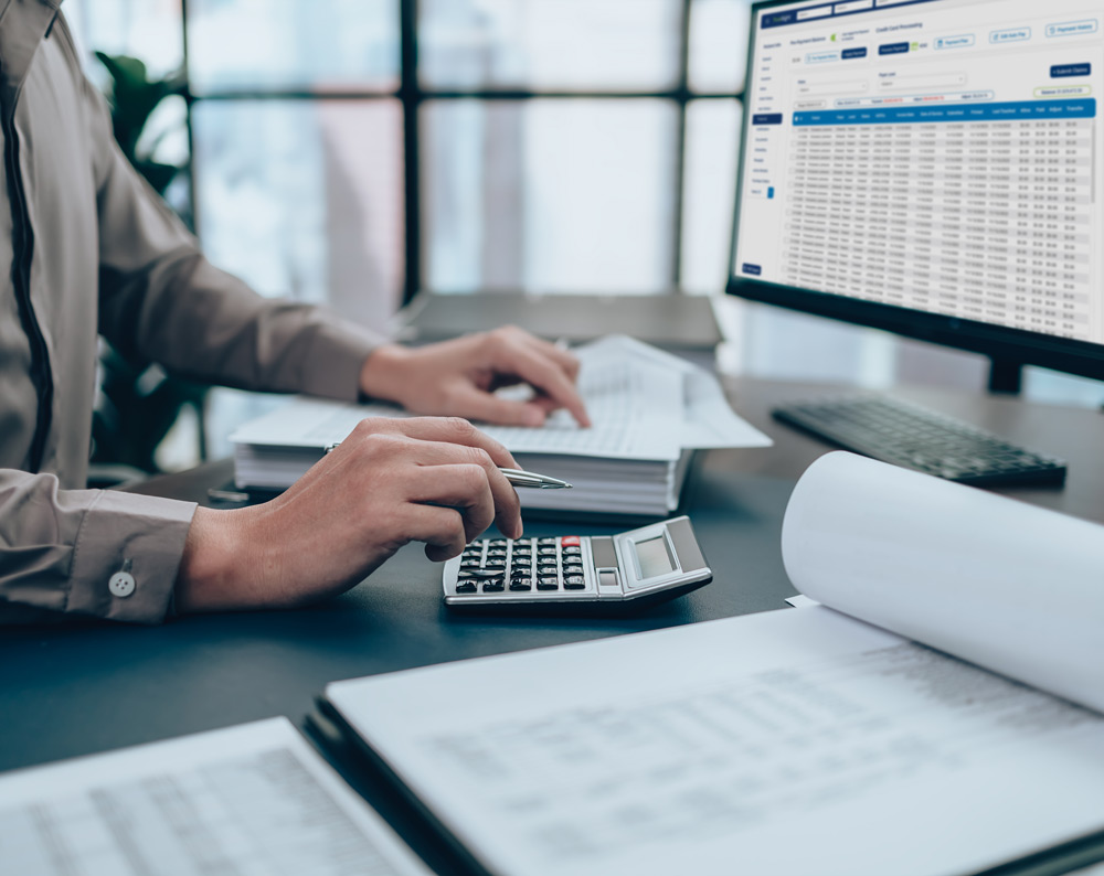 auditors desk with computer, papers, and calculator