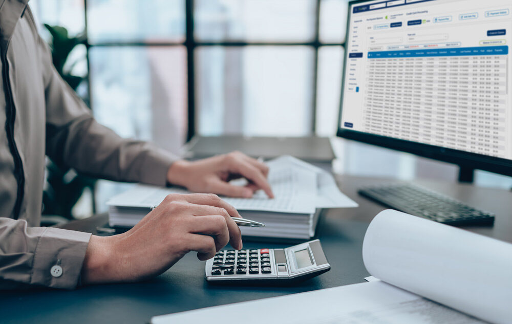 auditors desk with computer, papers, and calculator