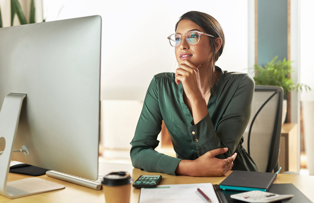 businesswoman looking at her computer screen at work