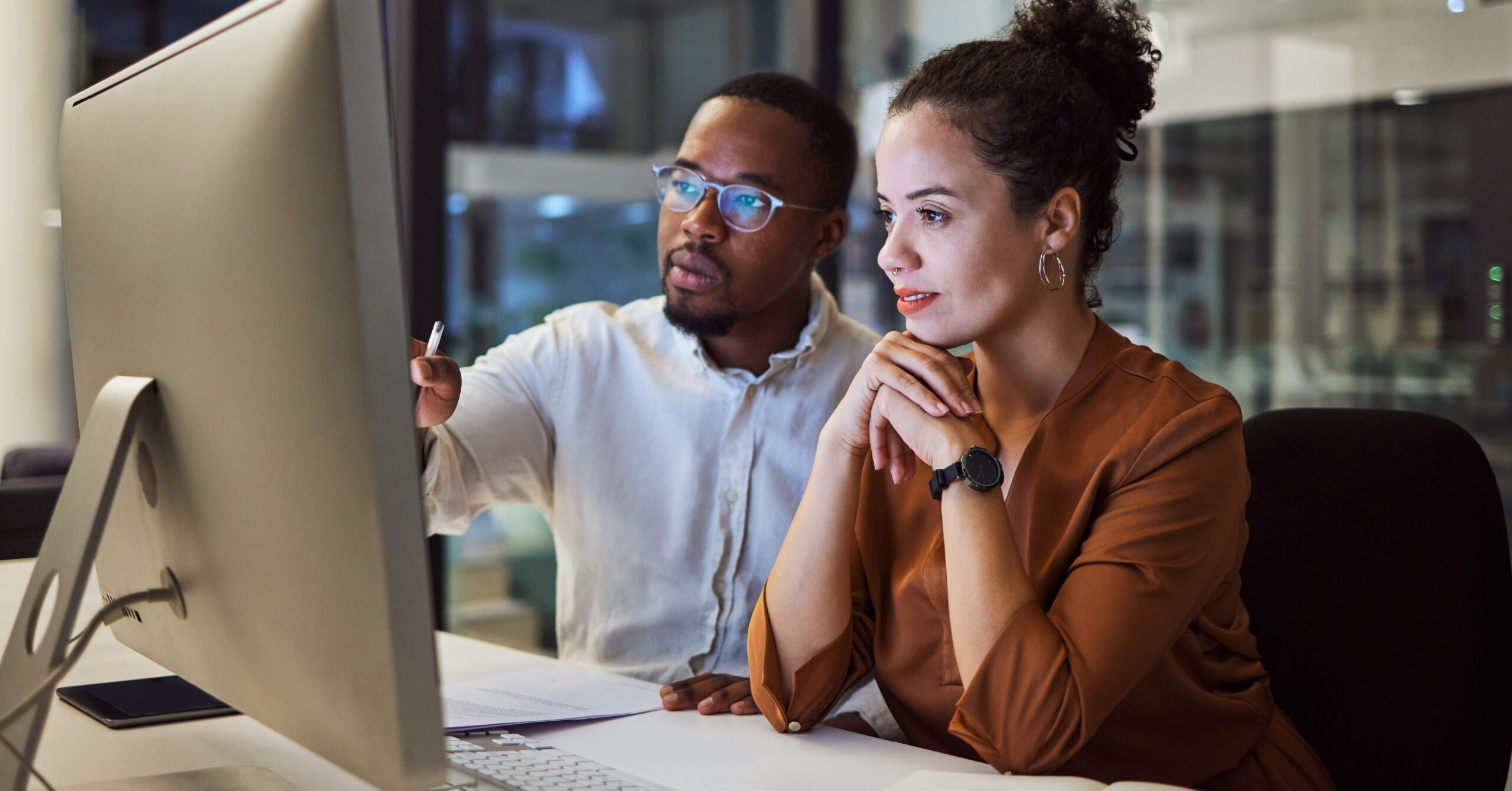a man and woman looking at the screen