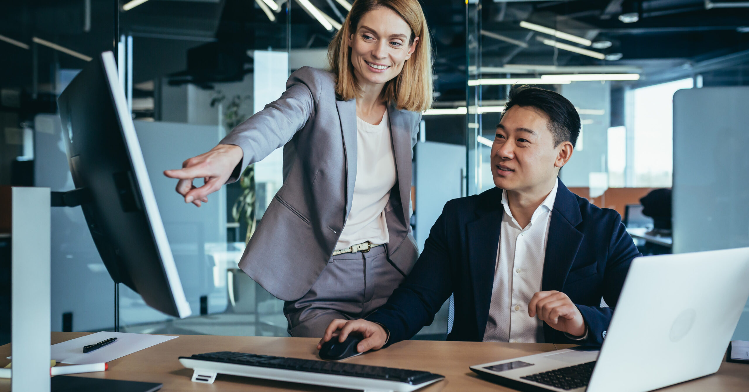 colleagues pointing at computer screen